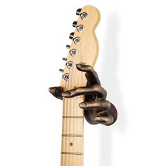 a hand holding the neck of a guitar