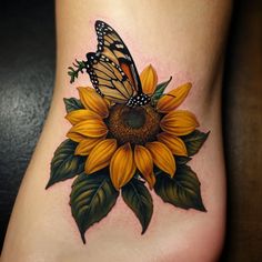 a sunflower with a butterfly on it's side tattoo by the artist mark