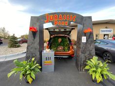 the trunk of a car is open with plants growing out of it's trunk