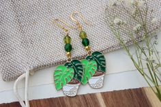 Handmade emerald monstera earrings with Czech glass beads plated in 18k gold plated earwire. This would make a wonderful gift for anyone who loves plants. They dangle 2 1/2 inches (L) and are heavy weight. ✦Enjoy one Free Polishing Cloth with your order Designed and handmade in my home studio, my jewelry is packaged with care in a gift box and ready for gift giving. Let me know if you have any questions, I'd be happy to answer them. Thank you for viewing. Copyright © 2023 Martha's Studio Designs Green Beaded Pierced Earrings, Trendy Leaf-shaped Jewelry Gift, Trendy Leaf-shaped Earrings For Gifts, Gift Green 14k Gold Filled Earrings, Green 14k Gold Filled Earrings With Ear Wire, Handmade Leaf-shaped Everyday Jewelry, Everyday Handmade Leaf-shaped Jewelry, Handmade Green 14k Gold Filled Earrings, Nickel-free 14k Gold-filled Green Jewelry