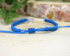 "--- ABOUT THIS BRACELET: A perfect gift for any tennis enthusiast! A silver toned tennis racquet charm is woven onto a hand-knotted hemp band in your choice of color. It is finished with an adjustable slide-knot closure, to ensure the most comfortable fit. Your bracelet will be brand new and handmade-to-order, just for you! --- HEMP COLOR: Choose one from the list of colors. The featured color is WHITE, and examples of the other colors are in the last pictures. --- SIZE: This bracelet can be ma Blue Sporty Bracelet For Sports, Sporty Blue Bracelet For Sports, List Of Colors, Hemp Jewelry, Tennis Coach, Racquets, Tennis Racquet, Team Gifts, Cadiz