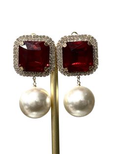 Enhance your elegant look with our Crystal and Drop Pearl Clip on Earrings. Adorned with sparkling crystals and rhinestones, these earrings add a touch of sophistication to any outfit. The drop pearl adds a classic touch, making them the perfect accessory for any formal occasion. Amplify your style with these timeless gems. Red Pearl Earrings For Formal Occasions, Evening Jewelry With Pearl Embellished Drop Earrings, Elegant Clip-on Crystal Earrings, Elegant Pearl Earrings With Sparkling Stones For Party, Evening Crystal Jewelry With Pearl Drop, Classic Pearl Earrings With Cubic Zirconia For Party, Classic Cubic Zirconia Pearl Earrings For Party, Evening Crystal Pearl Drop Earrings, Party Pearl Drop Crystal Earrings In Cubic Zirconia