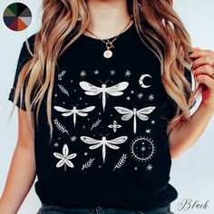 Lunar Dragonflies Unisex Tee Shirt | Boho Celestial Insect T-shirt | Cottagecore Goblincore Clothes ✔️ Soft, light and comfortable unisex short sleeve tee ✔️ 100% Airlume combed and ringspun cotton (fiber content may vary for different colours*) ✔️ Light fabric (4.2 oz/yd² (142 g/m ✔️ Retail fit 📏 Runs true to size ✔️ Dual side seams for structural support of the garment help hold its shape longer ✔️ Ribbed knit elastic collars to bolster shaping, twill taped shoulders to prevent stretching and Black Bohemian Crew Neck Top, Black Bohemian Cotton T-shirt, Black Bohemian Relaxed Fit Shirt, Black Bohemian T-shirt With Relaxed Fit, Black Bohemian Relaxed Fit T-shirt, Boho T Shirt, Goblincore Clothes, Cottagecore Goblincore, Celestial Shirt