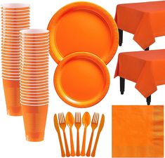 an orange table setting with plates, napkins and forks