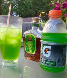 two bottles of liquid sitting next to each other on a table