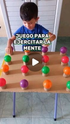 a young boy playing with an interactive board game