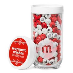 a jar filled with lots of red and white balls next to a container full of buttons