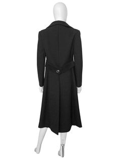 "A spectacular Pierre Cardin coat from the late 1960s. Made of a deep black wool fabric, featuring a clean, sharp cut with a double-breasted closure with the original silver-tone elliptical buttons, large geometrical soft black suede appliqués at the waist that run around the back as well as decorative stitching. Hidden side pockets. Midi-length. The coat is warm and perfect for fall and winter. Fully lined. Made in France. Condition Excellent, no flaws. Size No tag, will fit a D 34-36, F 36-38, Black Wool Fabric, Late 1960s, Decorative Stitching, Coat Black, Deep Black, Pierre Cardin, Space Age, 1960s Vintage, Wool Fabric