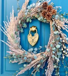 a blue door with a wreath and pine cones on it