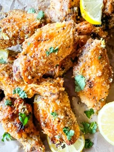 chicken wings with lemon wedges and parsley on the side, ready to be eaten