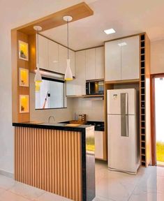 a kitchen with white cabinets and black counter top next to a refrigerator freezer oven