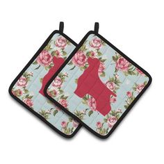 two pot holders with flowers on them and one has a red dog in the center