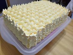 a large cake sitting on top of a plastic container