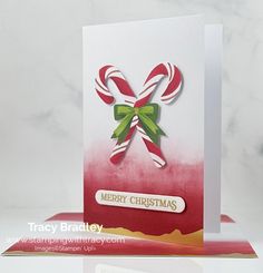 a christmas card with candy canes on it