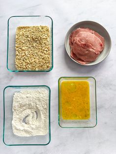 four different types of food in bowls on a white counter top, including meat and flour