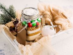 a mason jar filled with candy and christmas decorations