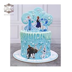 a frozen princess birthday cake with blue icing and frosting on the top, surrounded by snowflakes