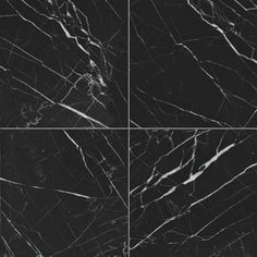 four black marble tiles with white veining on the edges and bottom, all in different angles