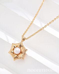 Meet our enchanting, understated 18k gold-plated choker, Moonlight Starlet. At its center, a radiant mother of pearl is nestled in a star-shaped pendant, framed by flowing, romantic rays. Each detail sparkles with a whimsical glow, adding a touch of celestial beauty to any occasion. ♥︎  DETAILS: ☽ Material: 18k Gold Plated Sterling Silver, Mother of Pearl ☽ Size: * Chain length is about 40cm + 6cm extension chain              * Pearl is about 5mm              * Width of starlet is approximately Elegant Star-shaped Clavicle Necklace, Elegant Rose Gold Necklace With Star Charm, Elegant Rose Gold Star Necklace, Elegant Gold Plated Charm Necklaces With Star Charm, Elegant Gold Plated Charm Necklace With Star, Elegant Star Charm Necklace, Tarnish Resistant, Elegant Star-shaped Tarnish Resistant Charm Necklace, Elegant Gold Necklace With Star Charm, Elegant Gold Star Necklace