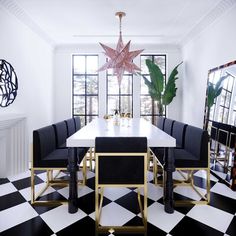 a dining room with black and white checkered flooring, gold accents and a star hanging from the ceiling