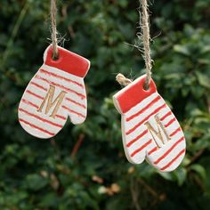 two red and white mittens hanging from strings