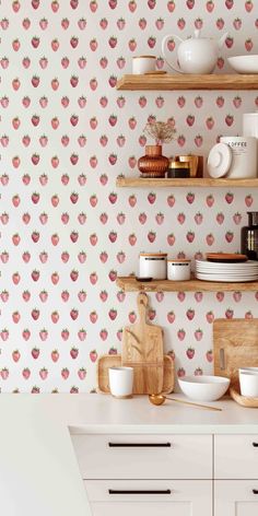 the wallpaper in this kitchen is designed with pink flowers and apples on white background