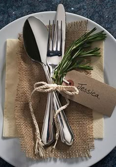 a white plate topped with silverware on top of a table