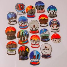 a collection of snow globes sitting on top of a white table next to each other