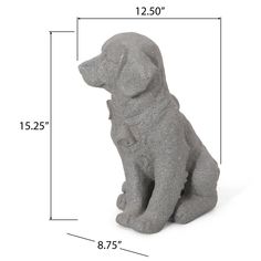 a gray dog statue sitting on top of a white floor next to a measuring line