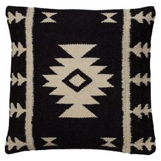 a black and white pillow with an arrow design on the front, sitting on a white background