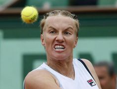 a woman hitting a tennis ball with her racket