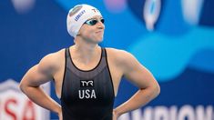 a woman standing in front of a swimming pool with her hands on her hips wearing a usa swimsuit