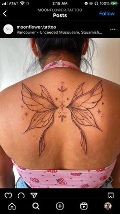 a woman with a butterfly tattoo on her back