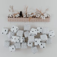 a person is placing small boxes on top of each other in the shape of christmas trees