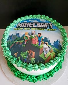 a birthday cake with an image of minecraft on the frosting and green icing