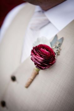 a man in a tuxedo with a boutonniere on his lapel