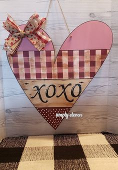 a wooden heart hanging on a wall