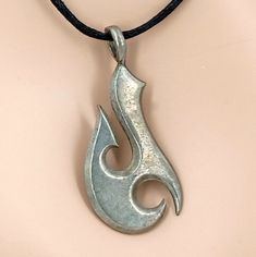 Lead Free Pewter Island Style Fishhook on a Black Adjustable Slide Cord Necklace USA made Pendant measures approximately 2 inches or 50mm High x 1 inch or 25mm Wide The Fish Hook is traditionally a symbol of strength, good luck and safe passage on the sea. One size fits most - youth to adult Slide knots toward each other to open and slip over your head. Slide knots toward or away from each other to adjust length In stock. Shipped daily from Florida USA Our jewelry items, parts, and shark's teeth Boys Necklace, Fish Hook Necklace, Hook Necklace, Surfer Style, Minimal Jewelry, Shark Teeth, Island Style, Florida Usa, Men's Necklace