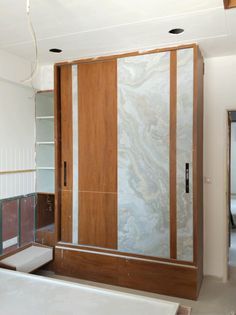 an empty bathroom with marbled walls and wooden doors