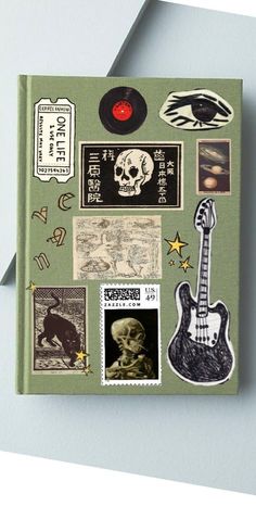 a book with various stickers and pictures on the cover, including an electric guitar