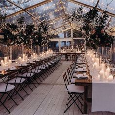 the tables are set up with candles and flowers in vases for an elegant wedding reception