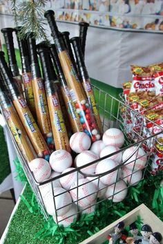 a basket filled with baseballs sitting on top of a table next to other items