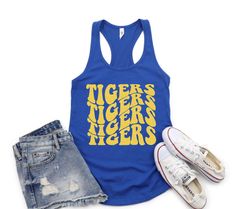 Cheer for your favorite baseball team with our personalized glitter team name tank top.  Your choice of Tank top color and glitter color design.  Next Level Brand Tank Top - Please size up for looser fit.  Please review size chart prior to placing your order.  This is women's fit cut tank top so if you prefer a looser fit, please size up a size.  TO ORDER: Choose Tank Color Choose Size (Size Up for a looser fit) Choose Glitter Design Color (shown on last color chart) Enter Team Name in Personalization section Check Out MATERIAL & FIT  60% combed ring spun cotton/40% polyester lightweight jersey This is a fit cut tank. I would suggest sizing up for a looser fit. ANY QUESTIONS, just send me a message! ❤CARE INSTRUCTIONS❤ Wash in Cold Water Tumble Dry on Low Heat or Hang Dry Do Not Iron Do No Cheer Tank Tops, Cheer Tank Tops Design, Cheer Merch, Baseball Tank Top, Baseball Tanks, Cut Tank Top, Glitter Design, Camping Outfits, Fan Shirts