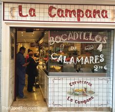 people are standing in front of the door of a restaurant that sells calamares