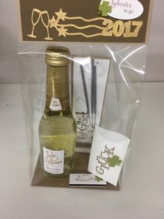 a bottle of wine and some cards in a package