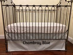 a baby crib with the name chambray blue on it's side