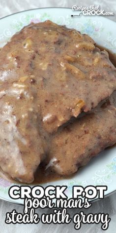 two pieces of meat covered in gravy on a plate