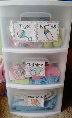 three plastic bins with labels on them that say toys, bottles, blankets and diapers