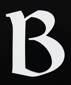 the letter b is made up of white letters on black paper and it appears to be cut out