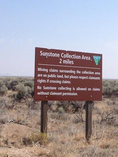 a sign in the middle of an open field that says sunstone collection area, 2 miles